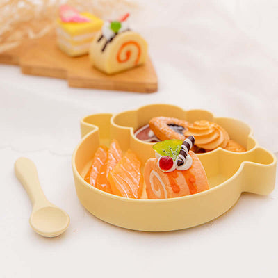 Baby Dinner Plate Food Grade Silicone Infant Learning To Eat Grid Plate with colorful desserts and a spoon.