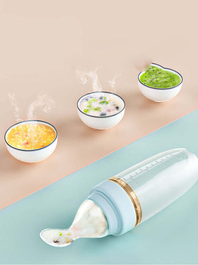 Tiny Royalty Baby Rice Cereal Spoon Soft Silicone Squeeze Rice Noodle with steaming bowls of baby food.