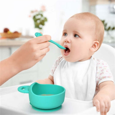 Tiny Royalty Food Grade Silicone Baby Bowl and Spoon with toddler eating in high chair.