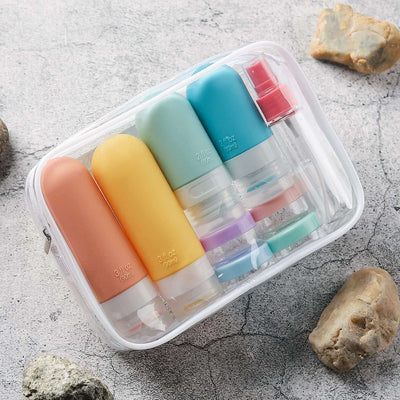 Tiny Royalty Storage Bottle Travel Set with colorful refillable bottles and clear travel pouch for shampoo and cosmetics.